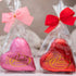 Coloured, foil wrapped Belgian chocolate hearts in gift bag tied with ribbon