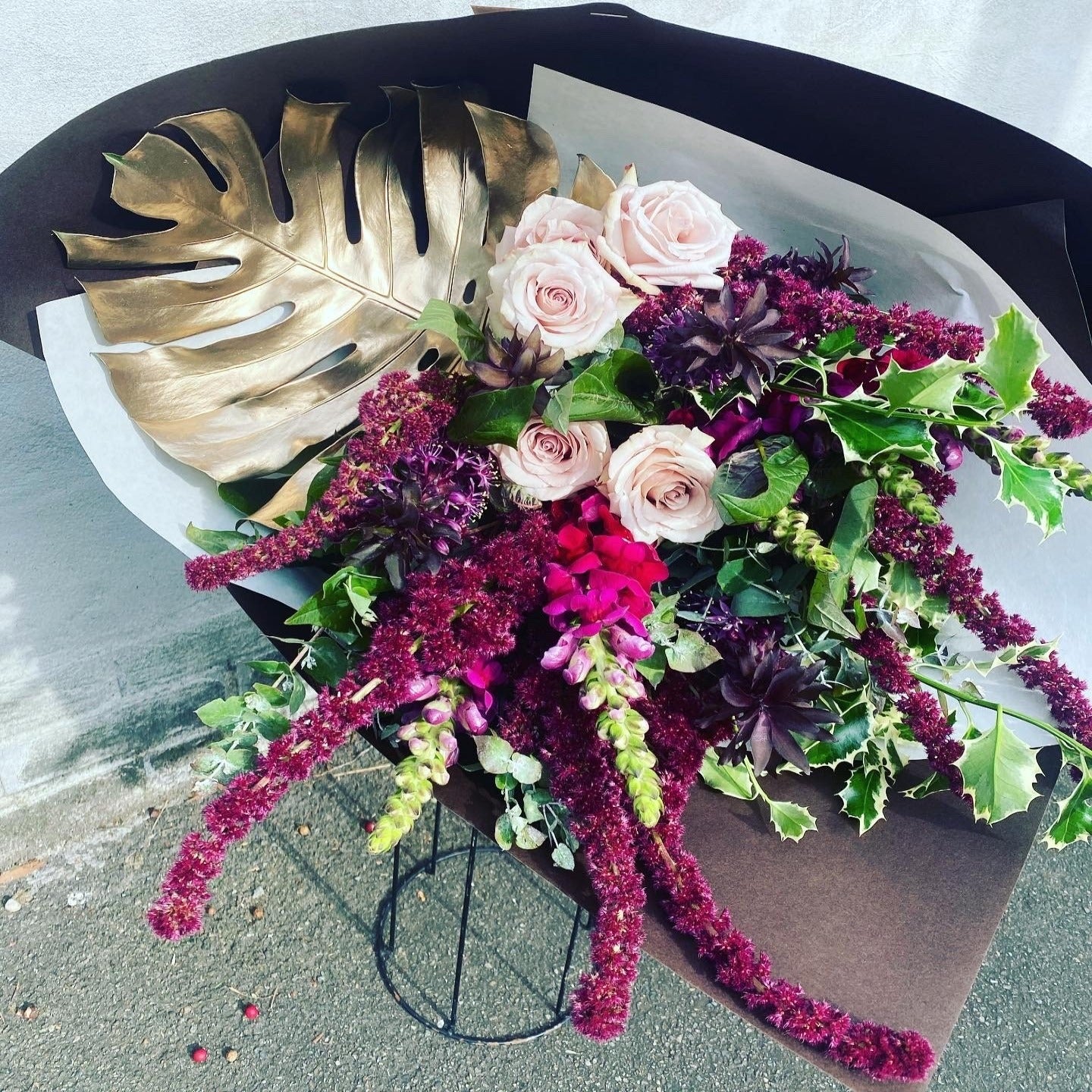 signature bouquet with premium roses, seasonal blooms, and gold leaf
