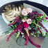 signature bouquet with premium roses, seasonal blooms, and gold leaf