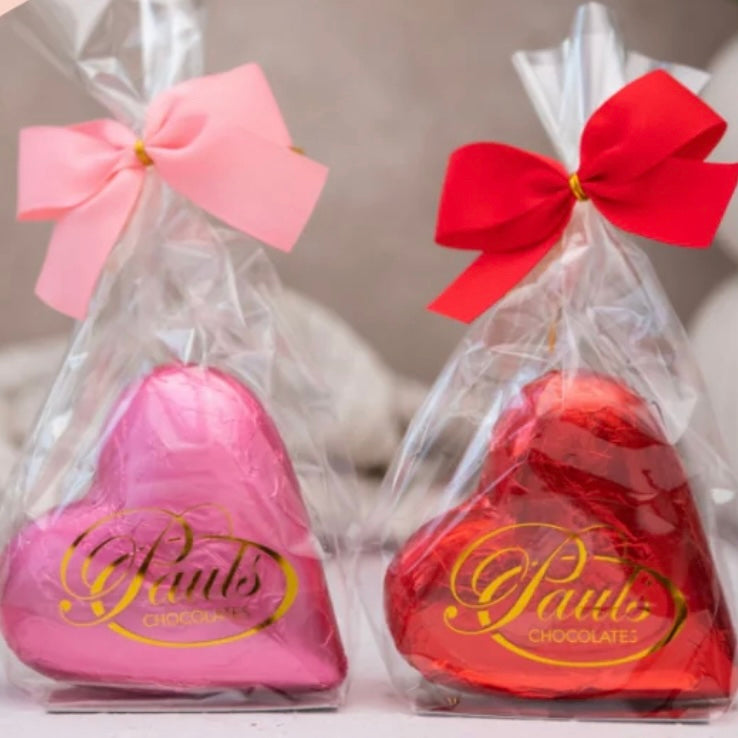 Coloured, foil wrapped Belgian chocolate hearts in gift bag tied with ribbon