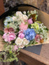 Feminine bouquet with pink and pastel flowers including roses and hydrangeas